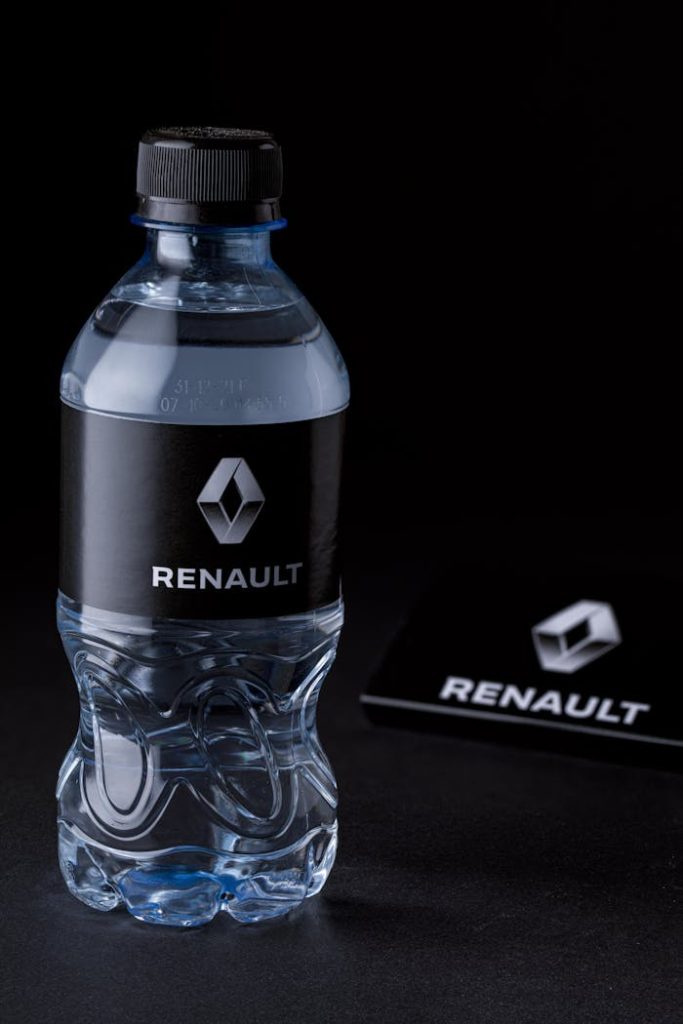Elegant Renault branded water bottle on dark background emphasizes purity and refreshment.